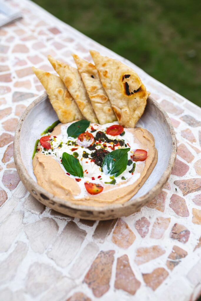 harissa hummus plated with pita