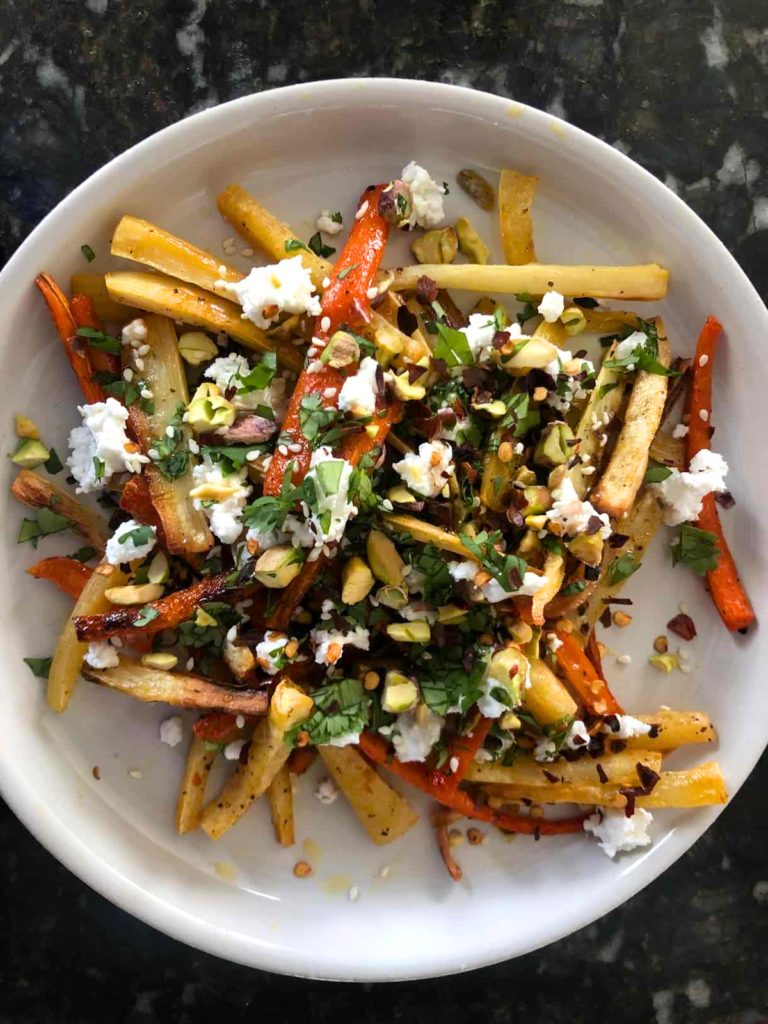 honey roasted carrots and parsnips topped with goat cheese, pistachios, cilantro, and sesame seeds